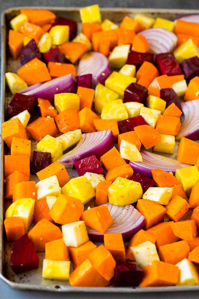 Roasted Root Vegetables Recipe | Roasted Sweet Potatoes | Roasted Beets | Roasted Carrots #carrots #beets #vegetables #sweetpotatoes #fall #parsnips #sidedish #jonep #cleaneating #healthy A mixture of root vegetables tossed with olive oil and garlic.