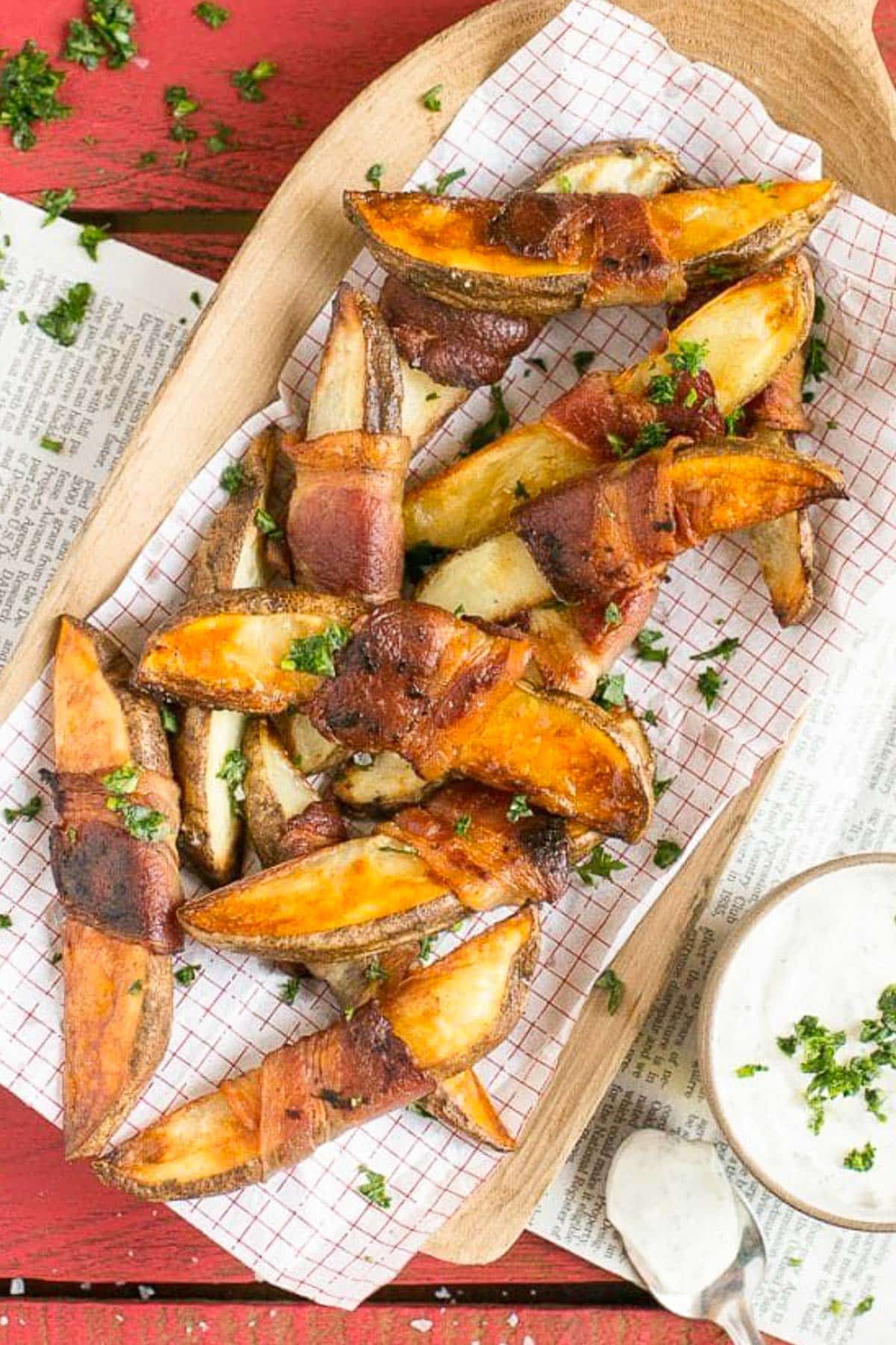 Bacon Wrapped Potato Wedges Recipe | Best Potato Wedges | Bacon Wrapped French Fries | Bacon Potato Wedges #bacon #potato #fries #dinner #jonep Potato wedges on a sheet of parchment paper that have been roasted.