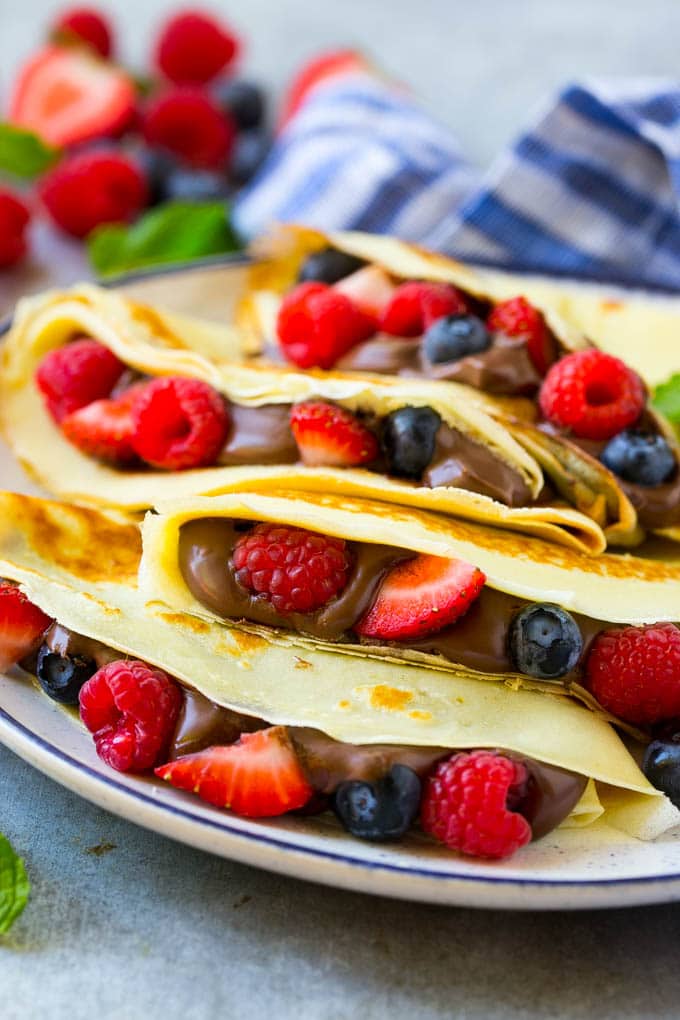 Nutella Crepes Recipe | Easy Crepes Recipe | Blender Crepes | Berry Crepes #crepes #nutella #nutellacrepes #blendercrepes #breakfast #jonep A stack of crepes that are stuffed full of chocolate Nutella spread and fresh berries.