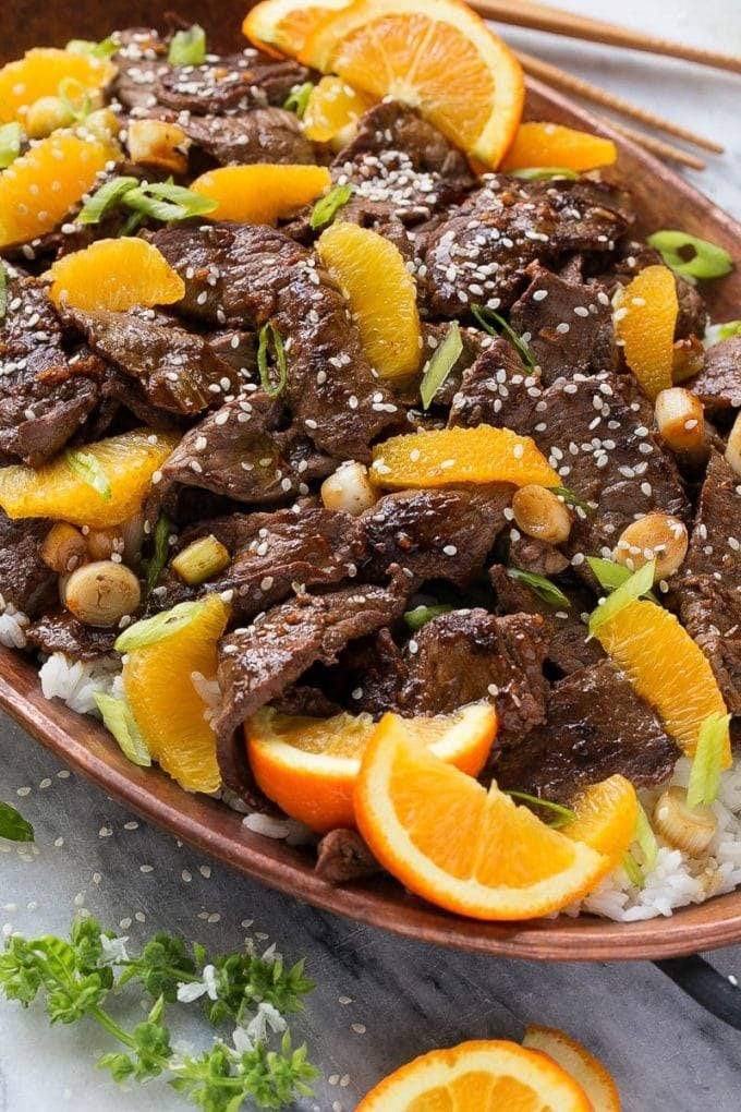 Orange Beef Stir Fry Recipe | 4 Ingredient Orange Beef | Easy Orange Beef #orange #beef #stirfry #asian #dinner #jonep Orange beef topped with green onions and sesame seeds.