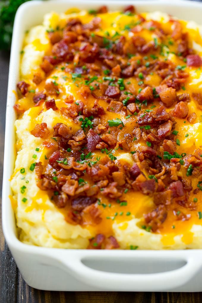 Loaded Mashed Potato Casserole Recipe | Loaded Potatoes | Bacon Mashed Potatoes | Thanksgiving Mashed Potatoes #potatoes #bacon #cheese #casserole #Thanksgiving #dinner #jonep A casserole of loaded mashed potatoes topped with cheddar cheese, crispy bacon and chives.