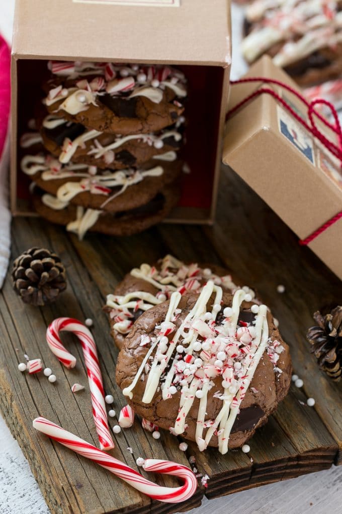 Peppermint Bark Cookie | Easy Peppermint Bark Cookies | Christmas Cookies | Peppermint Bark Cookies | Chocolate Peppermint Cookie #peppermint #peppermintbark #cookies #christmas #holiday #dessert #jonep Chocolate Peppermint Cookies topped with crushed candy canes in a gift box.
