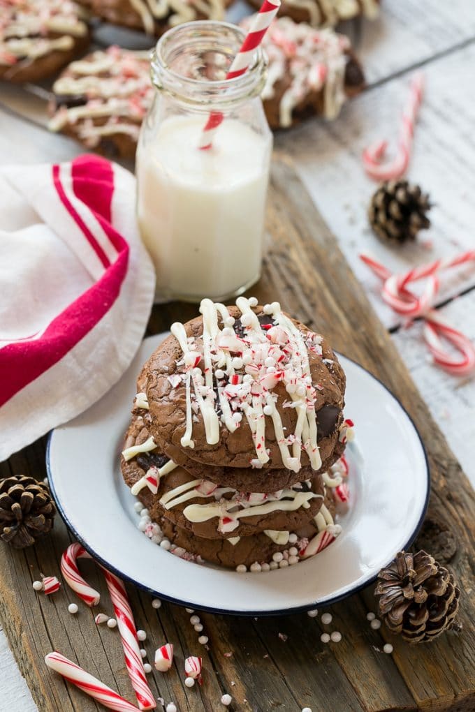 Peppermint Bark Cookie | Easy Peppermint Bark Cookies | Christmas Cookies | Peppermint Bark Cookies | Chocolate Peppermint Cookie #peppermint #peppermintbark #cookies #christmas #holiday #dessert #jonep A plate of chocolate peppermint bark cookies with a bottle of milk on the side.