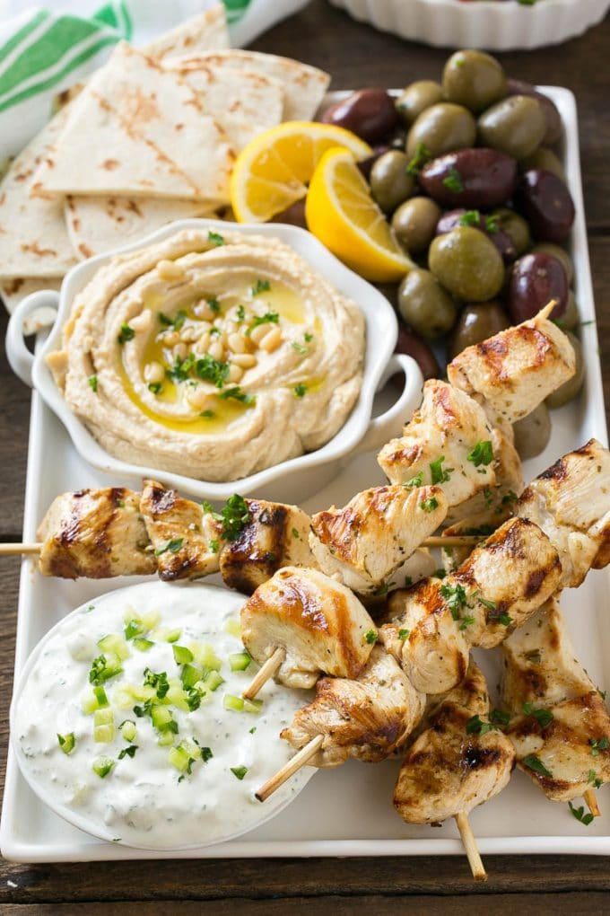 Greek Chicken Souvlaki Recipe | Easy Greek Chicken | Chicken Souvlaki | Greek Chicken Skewers | Easy Greek Chicken Skewers #chicken #kabobs #glutenfree #keto #lowcarb #grilling #jonep Chicken souvlaki skewers marinated in lemon and herbs, then grilled. Served with olives, hummus and pita bread.