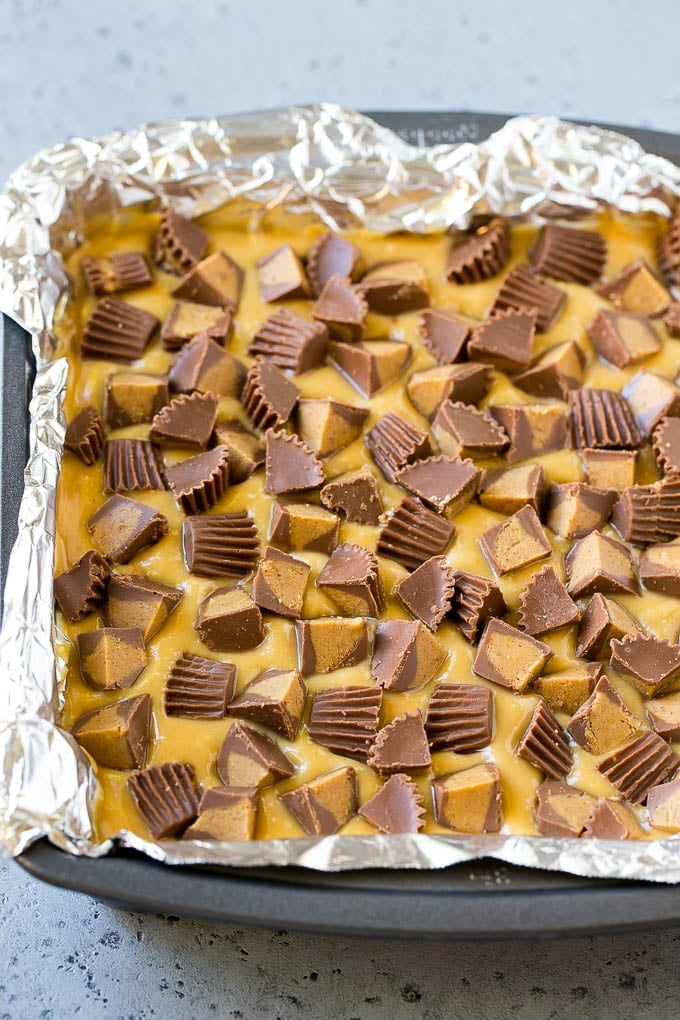 Chocolate Peanut Butter Fudge Recipe | Peanut Butter Cup Fudge | Easy Fudge Recipe #chocolate #peanutbutter #fudge #baking #dessert #jonep Layered peanut butter chocolate fudge in a square pan.
