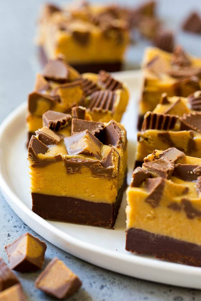 Chocolate Peanut Butter Fudge Recipe | Peanut Butter Cup Fudge | Easy Fudge Recipe #chocolate #peanutbutter #fudge #baking #dessert #jonep Squares of chocolate peanut butter fudge topped with peanut butter cups.