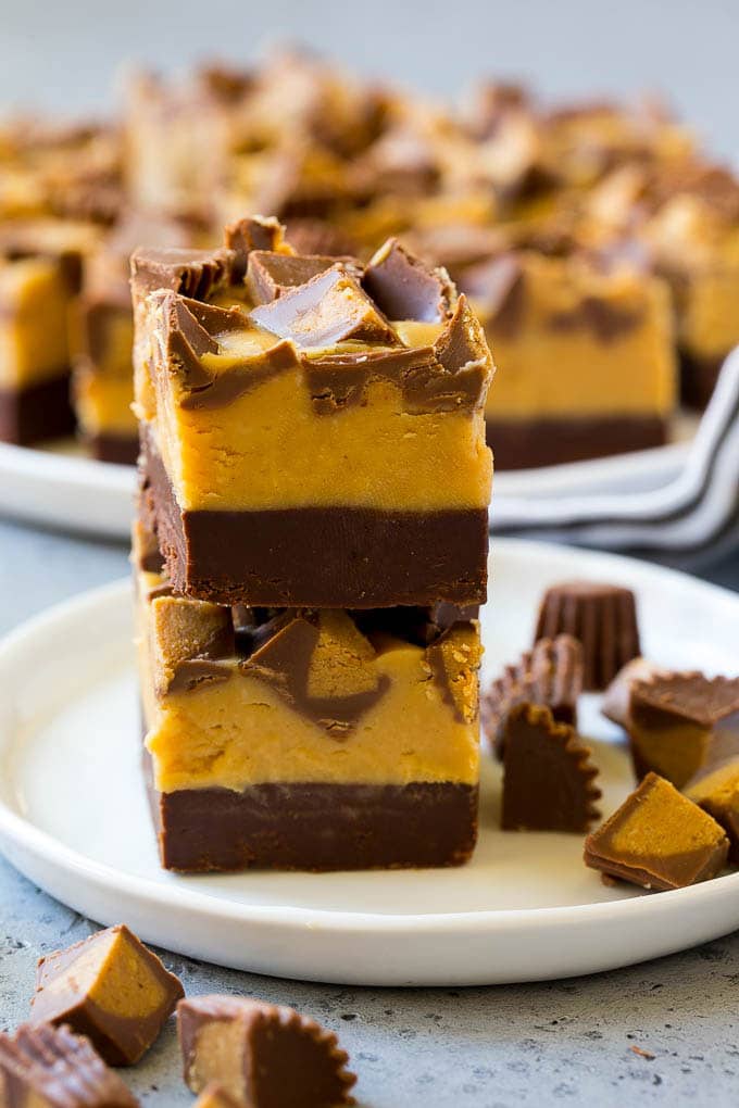 Chocolate Peanut Butter Fudge Recipe | Peanut Butter Cup Fudge | Easy Fudge Recipe #chocolate #peanutbutter #fudge #baking #dessert #jonep Stacked pieces of chocolate peanut butter fudge on a plate.