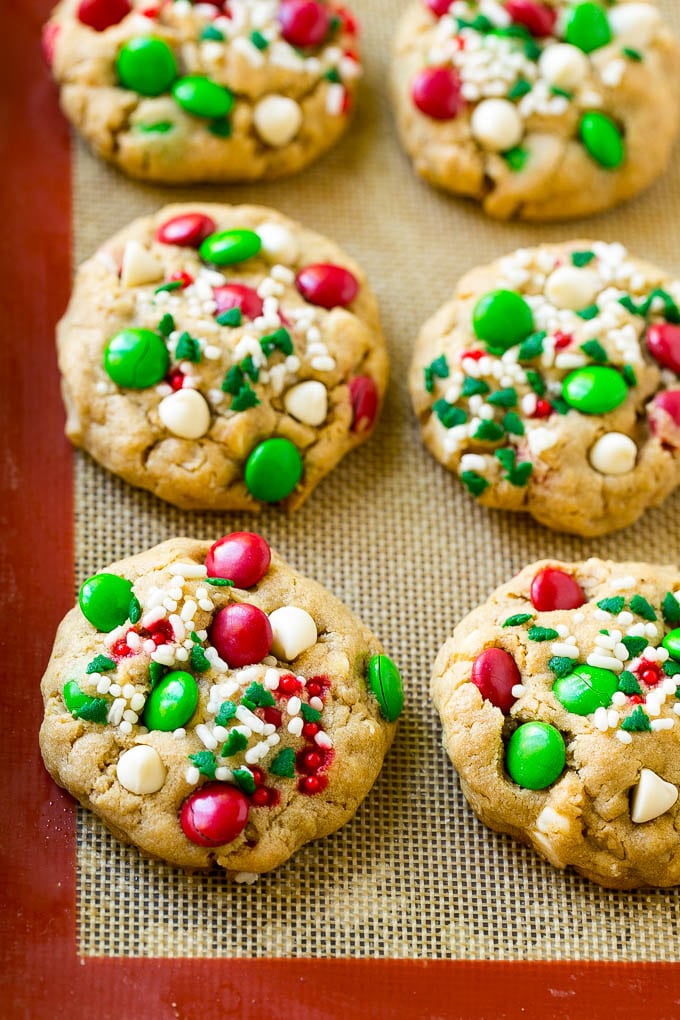 Christmas Monster Cookies Recipe | Oatmeal Cookies | Peanut Butter Cookies | M&M's Cookies #baking #cookies #dessert #peanutbutter #chocolate #jonep #christmas #sprinkles Baked Christmas cookies on a sheet pan.