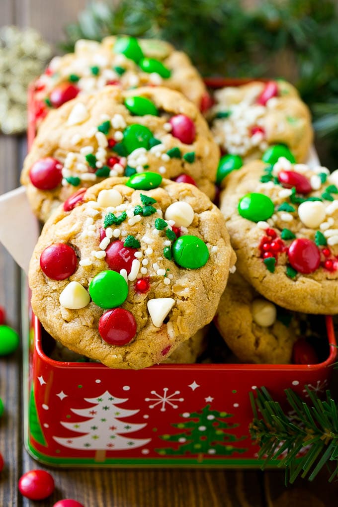 Christmas Monster Cookies Recipe | Oatmeal Cookies | Peanut Butter Cookies | M&M's Cookies #baking #cookies #dessert #peanutbutter #chocolate #jonep #christmas #sprinkles Christmas monster cookies in a gift tin.