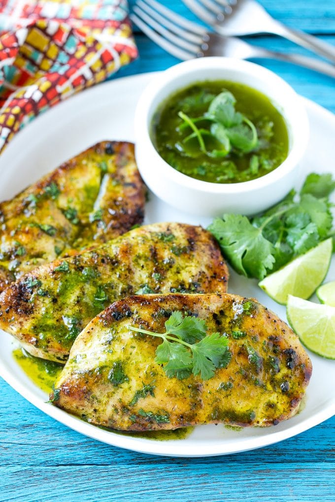 Cilantro Lime Chicken | Grilled Chicken #chicken #grilling #cilantro #lime #dinner #jonep Cilantro lime chicken topped with sauce and served with lime wedges.