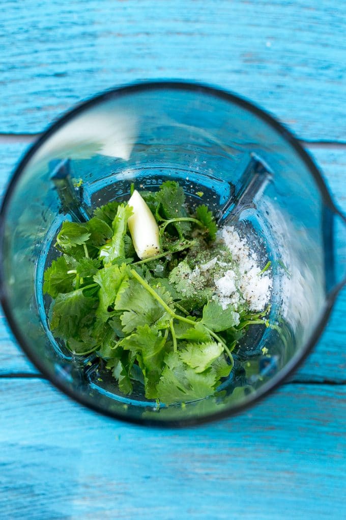 Cilantro Lime Chicken | Grilled Chicken #chicken #grilling #cilantro #lime #dinner #jonep A blender full of cilantro leaves, garlic, lime juice and olive oil.