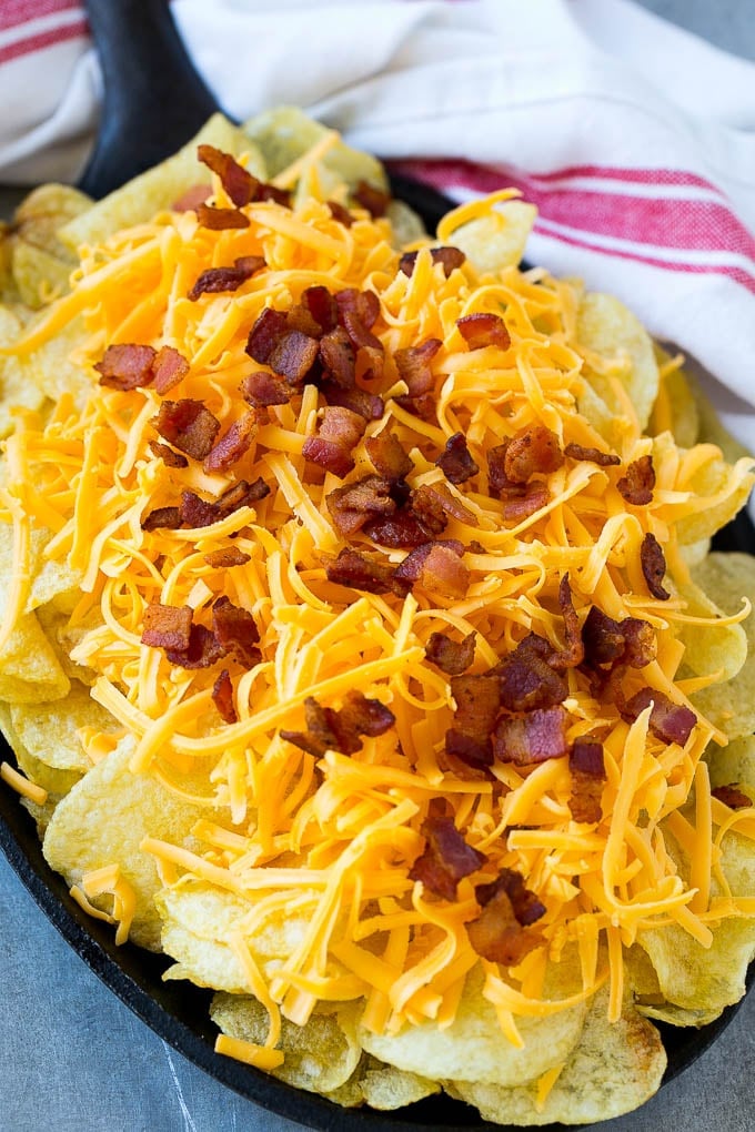 Irish Nachos Recipe | Potato Nachos | Potato Chip Recipe | Appetizer Recipe #nachos #potatoes #cheese #bacon #appetizer #jonep Kettle chips topped with shredded cheese and bacon.