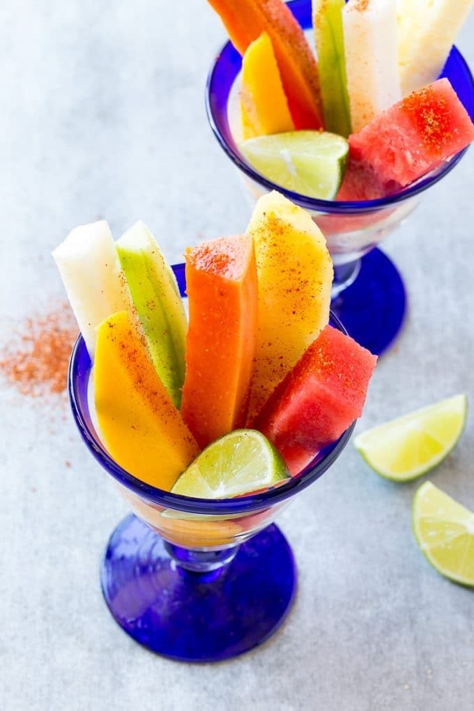 Mexican Fruit Cups | Fruit Cups | Mexican Fruit | Tropical Fruit #fruit #fruitcup #watermelon #pineapple #snack #healthy #jonep Mexican fruit cups with an assortment of fruit, topped with chili lime seasoning.