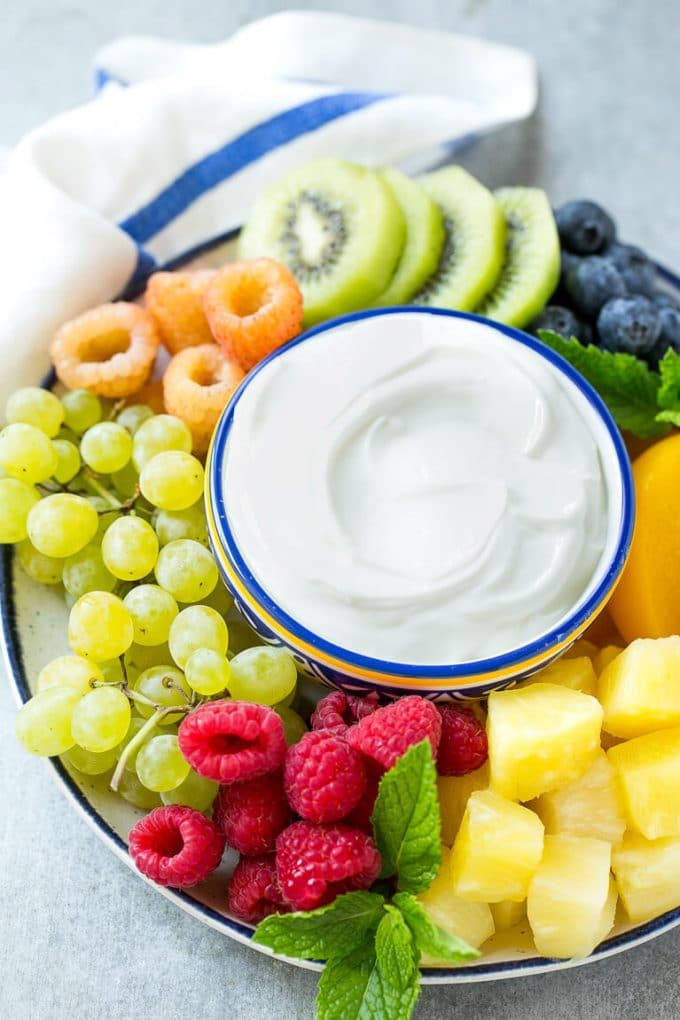 Cream Cheese Fruit Dip | Fruit Recipe | Fruit Dip #fruit #dip #creamcheese #snack #dessert #jonep A bowl of cream cheese fruit dip surrounded by colorful fruit.