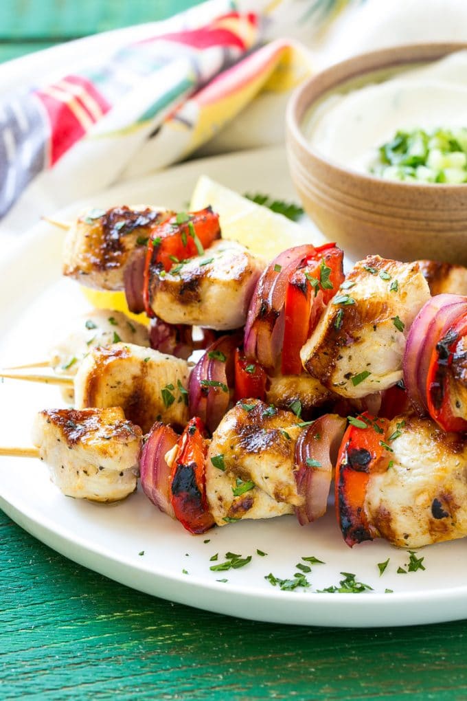 Greek Chicken Kabobs | Grilled Chicken Kabobs | Healthy Chicken Recipe | Greek Chicken #greekfood #chicken #grilling #grilledchicken #kabobs #dinner #jonep A stack of Greek chicken skewers made with peppers and onions.