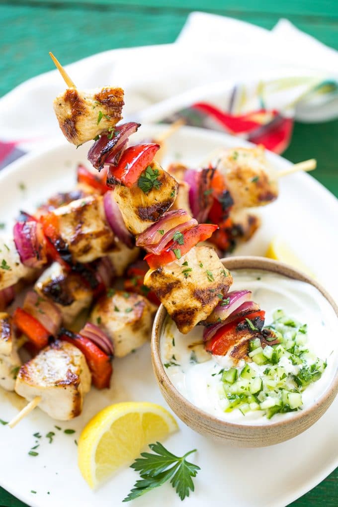 Greek Chicken Kabobs | Grilled Chicken Kabobs | Healthy Chicken Recipe | Greek Chicken #greekfood #chicken #grilling #grilledchicken #kabobs #dinner #jonep Skewered meat and veggies being dipped onto cucumber yogurt sauce.