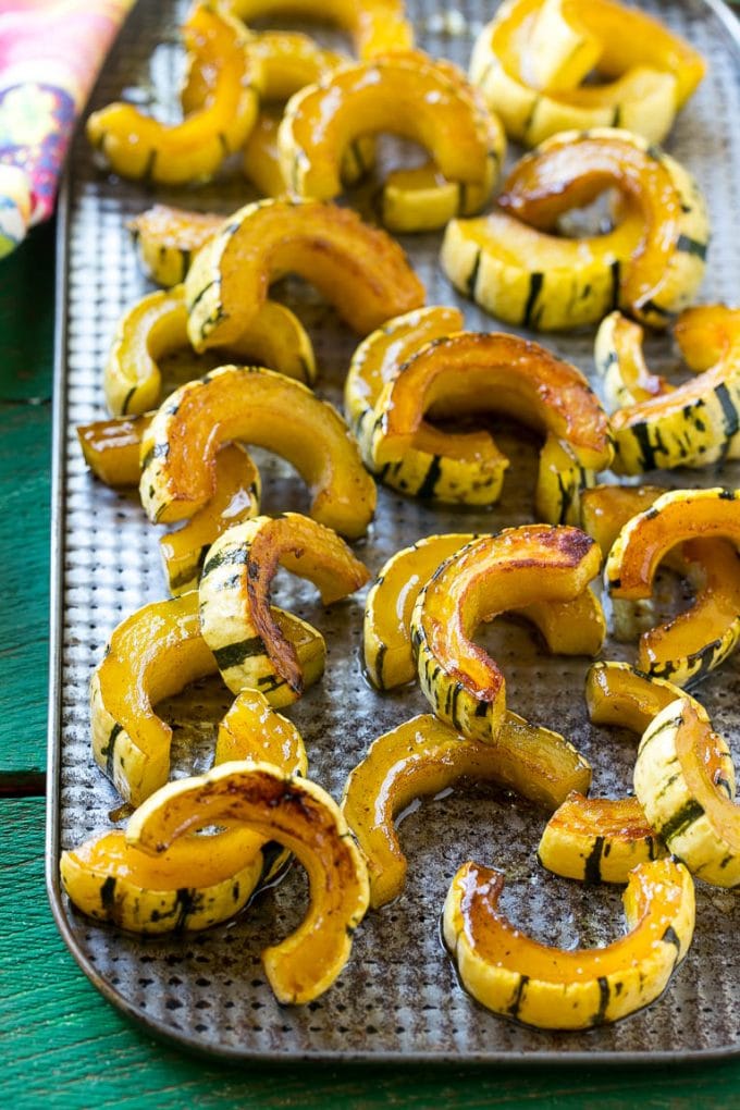 Brown Sugar Delicata Squash Recipe | Roasted Squash | Delicata Squash | Winter Squash Recipe #squash #wintersquash #brownsugar #sidedish #delicatasquash #dinner #jonep A sheet pan of a cooked winter squash recipe.