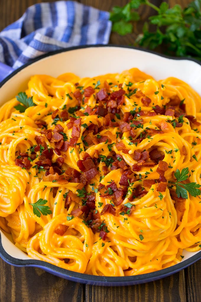 Butternut Squash Pasta Recipe #pasta #squash #bacon #fall #dinner #jonep Butternut squash pasta in a skillet topped with bacon and parsley.