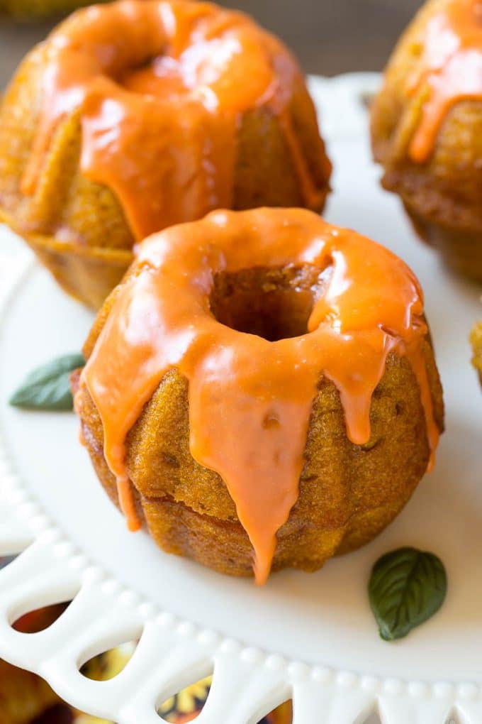 Pumpkin Spice Cake Recipe | Pumpkin Cake | Easy Pumpkin Cake | Thanksgiving Dessert #thanksgiving #pumpkin #cake #pumpkincake #spicecake #dessert #jonep #holiday Two bundt cakes stacked together with orange colored ganache on top.