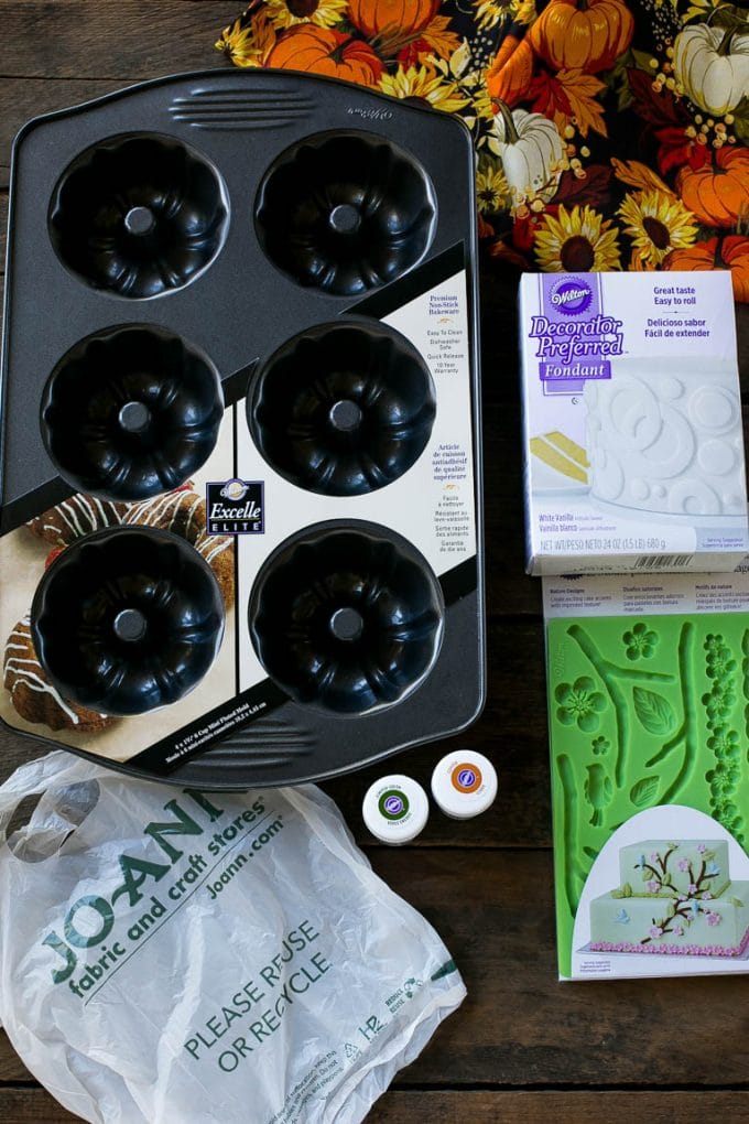 Pumpkin Spice Cake Recipe | Pumpkin Cake | Easy Pumpkin Cake | Thanksgiving Dessert #thanksgiving #pumpkin #cake #pumpkincake #spicecake #dessert #jonep #holiday Cake making tools including fondant, a cake pan, tubs of gel food color and fondant molds.