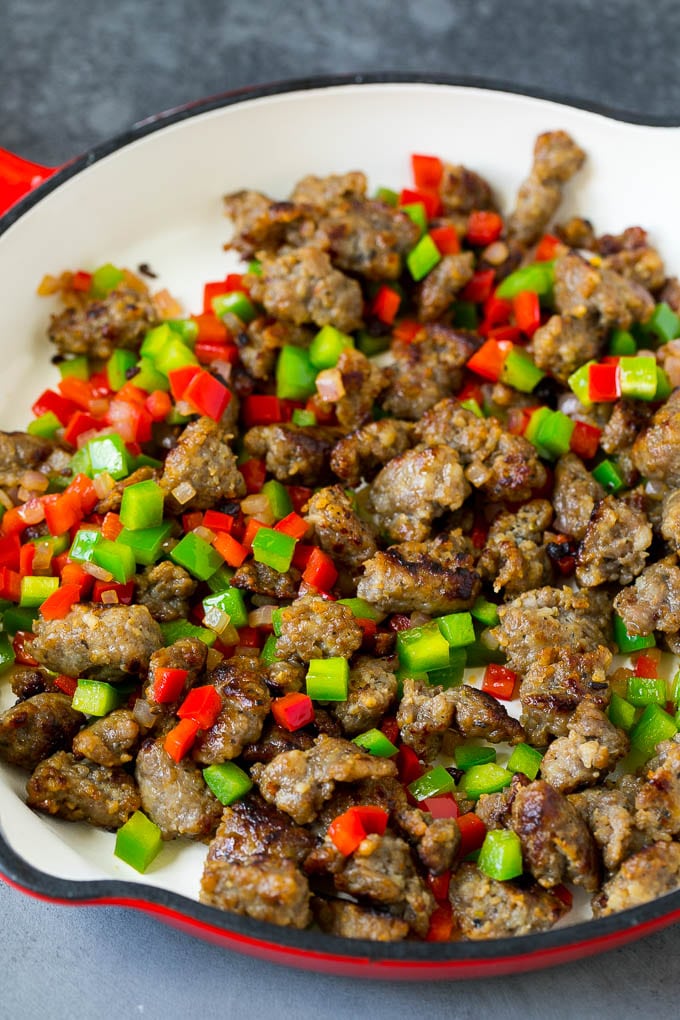 Sweet Potato Hash #sweetpotato #sausage #breakfast #brunch #jonep Sausage, onions and bell peppers in a skillet.