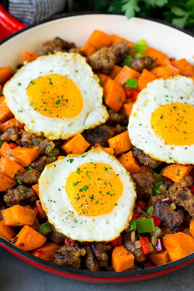 Sweet Potato Hash #sweetpotato #sausage #breakfast #brunch #jonep A pan of sweet potato hash topped with fried eggs.