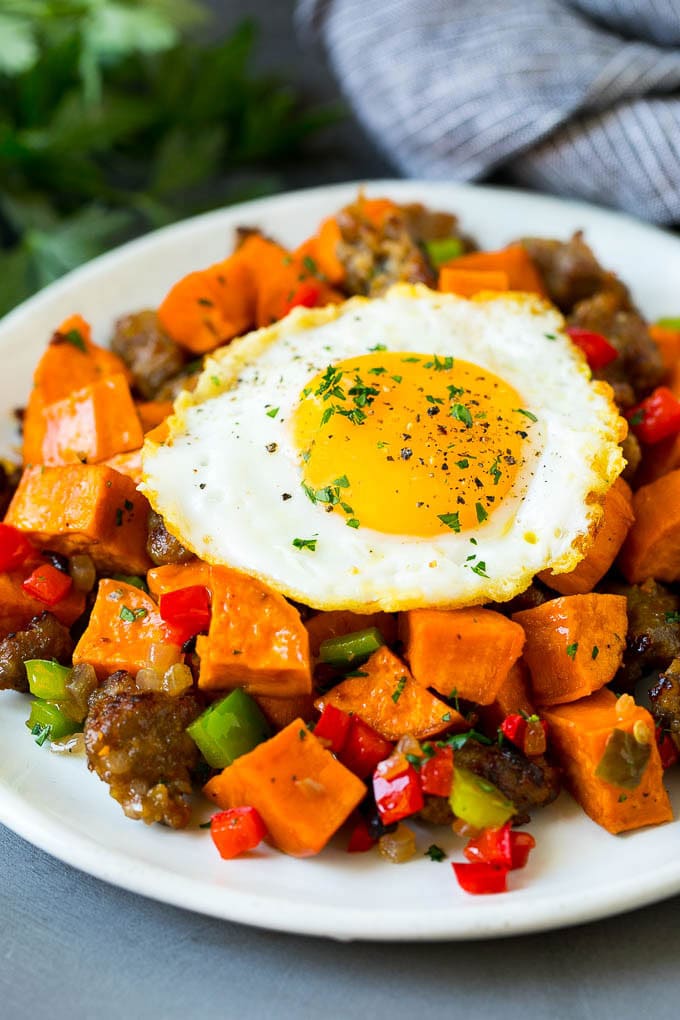 Sweet Potato Hash #sweetpotato #sausage #breakfast #brunch #jonep Sweet potato hash with sausage, topped with a fried egg.