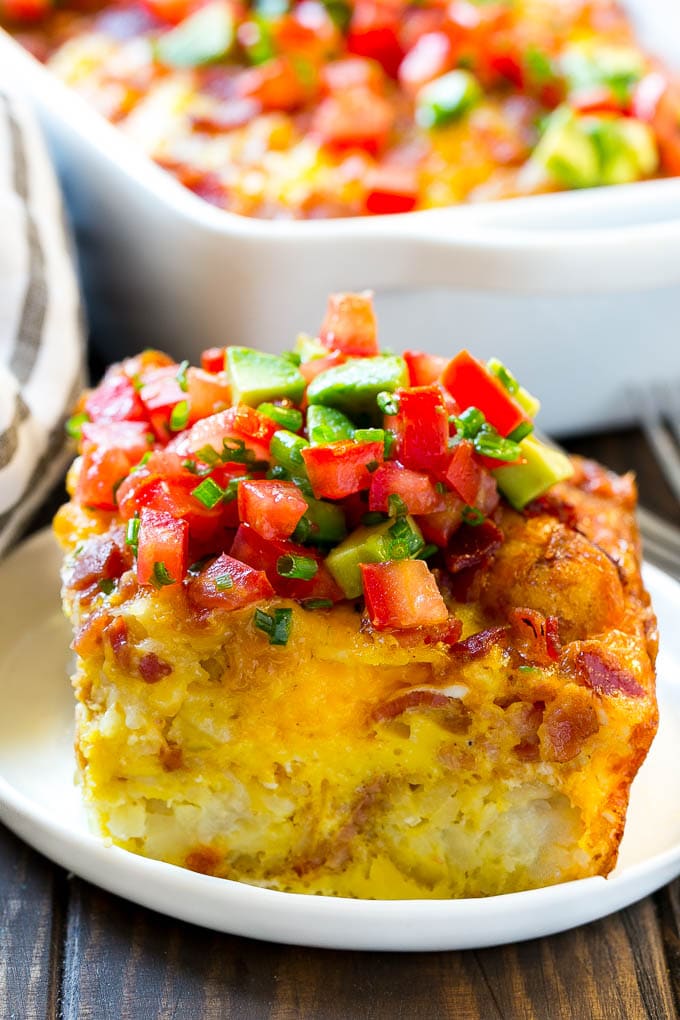 Breakfast Casserole with Bacon Recipe | Bacon and Egg Casserole | Egg Casserole with Bacon | Bacon Breakfast Casserole #eggs #bacon #casserole #breakfast #brunch #jonep A slice of egg casserole with potato tots in it.