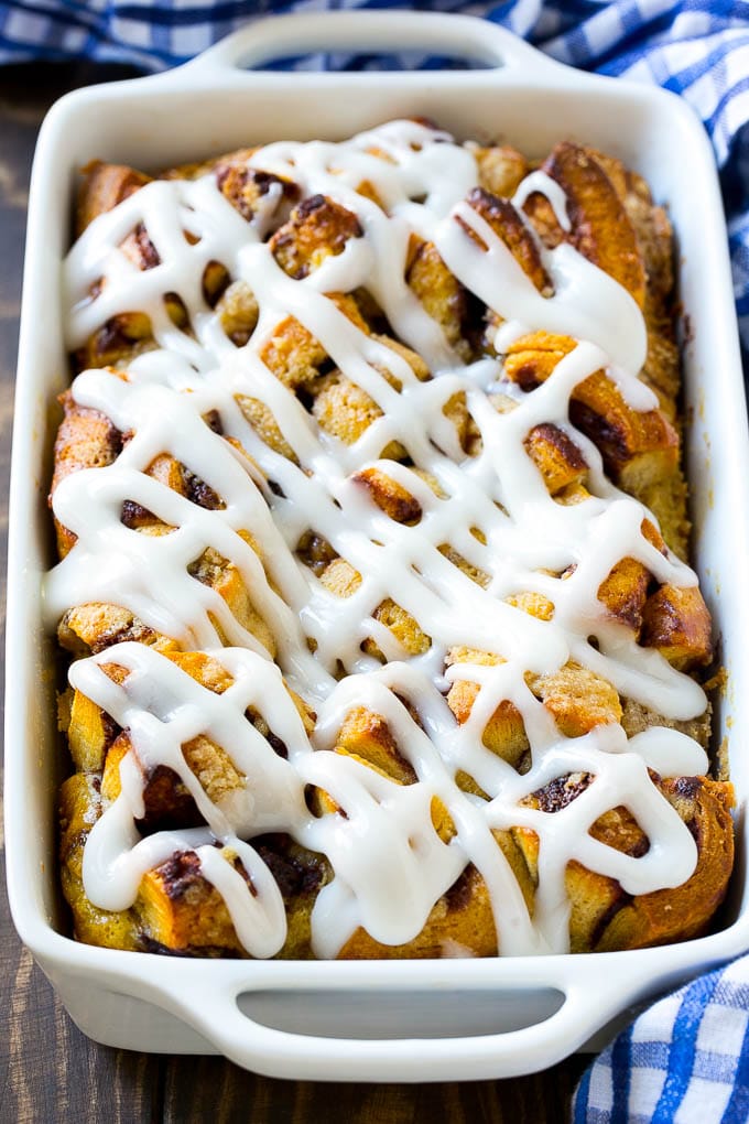 Cinnamon Roll French Toast Casserole | Cinnamon Roll French Toast Bake | Cinnamon Roll French Toast | Cinnamon French Toast #casserole #frenchtoast #cinnamonrolls #breakfast #jonep A casserole dish of cinnamon roll french toast with icing poured over the top.