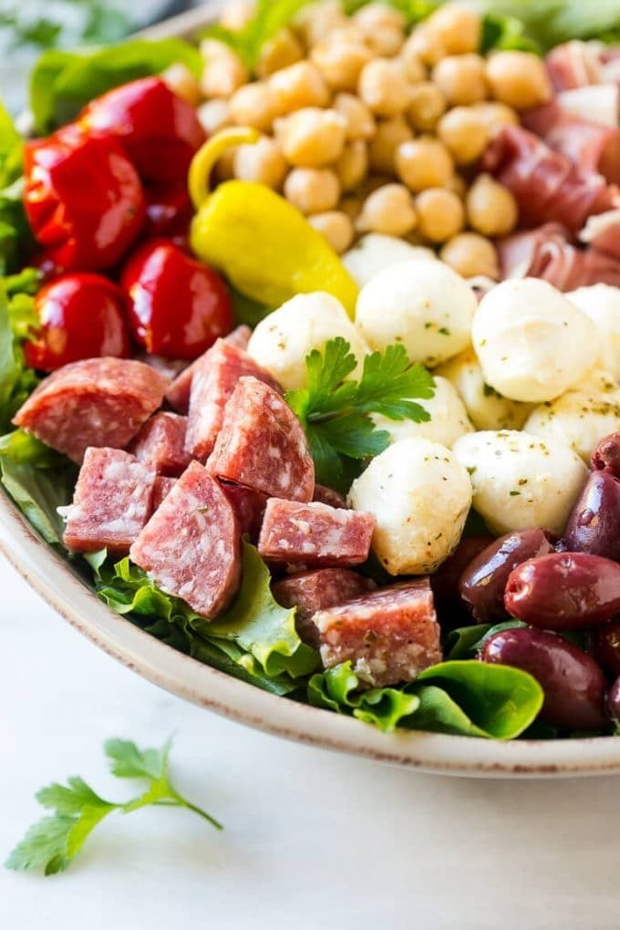 Antipasto Salad Recipe | Italian Salad | Main Course Salad | Antipasto Recipe #salad #salami #italianfood #dinner #lunch #jonep A bed of greens topped with antipasto salad including meats, cheeses, beans and vegetables.