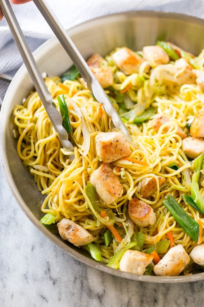 Chicken Chow Mein Recipe | Easy Chicken Recipe | Chow Mein | Chinese Food #chowmein #takeout #asianfood #jonep A pan of chicken chow mein with tongs pulling out a serving.