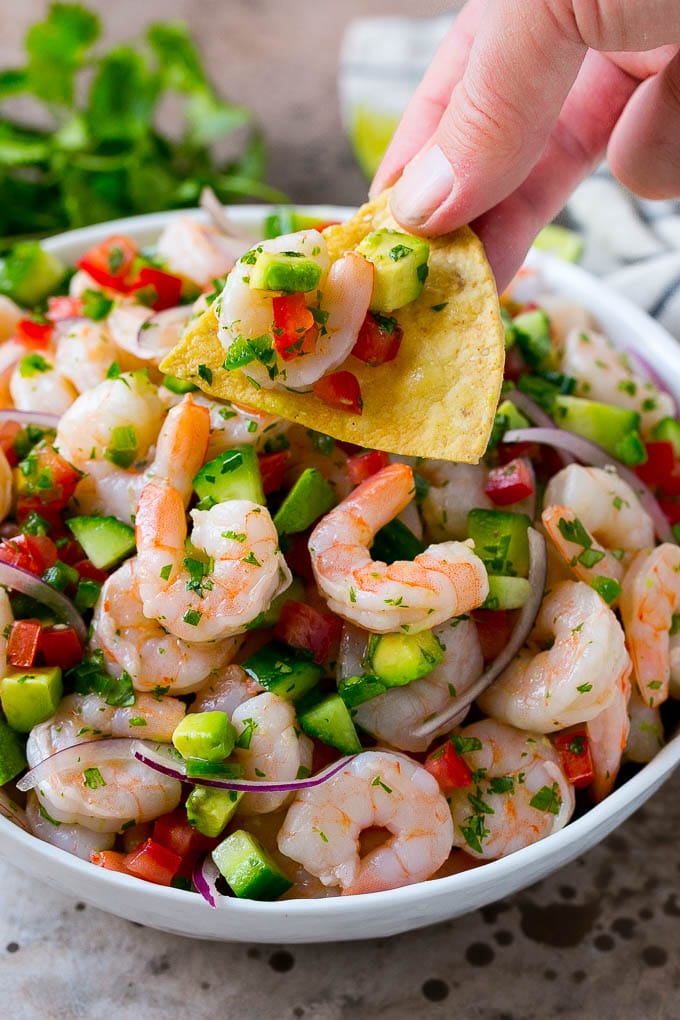 Shrimp Ceviche Recipe | Mexican Shrimp | Marinated Shrimp #shrimp #ceviche #cleaneating #healthy #lowcarb #keto #glutenfree #dinner #appetizer #jonep A bowl of shrimp ceviche with a tortilla chip scooping some out.