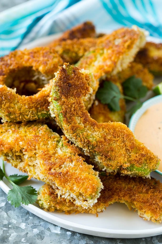 Avocado Fries Recipe | Fried Avocado | Avocado Fritters #avocado #appetizer #snack #jonep A plate of avocado fries garnished with fresh cilantro.