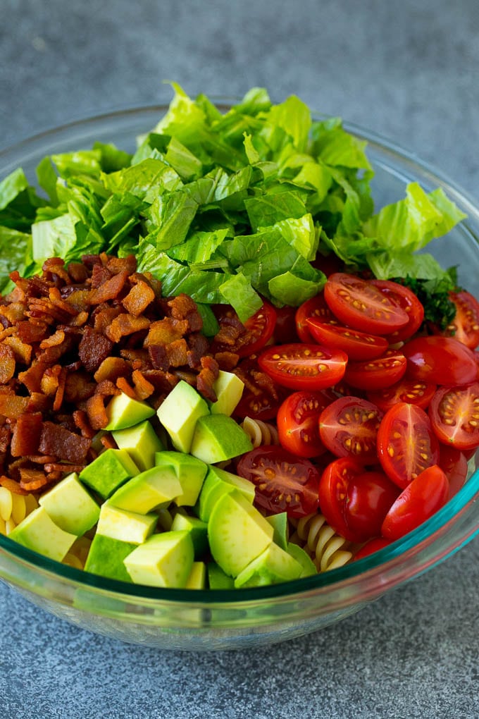 BLT Pasta Salad Recipe | Easy Pasta Salad | Bacon Pasta Salad #salad #pasta #blt #bacon #avocado #dinner #jonep Bacon, lettuce, tomato, pasta and avocado in a bowl.