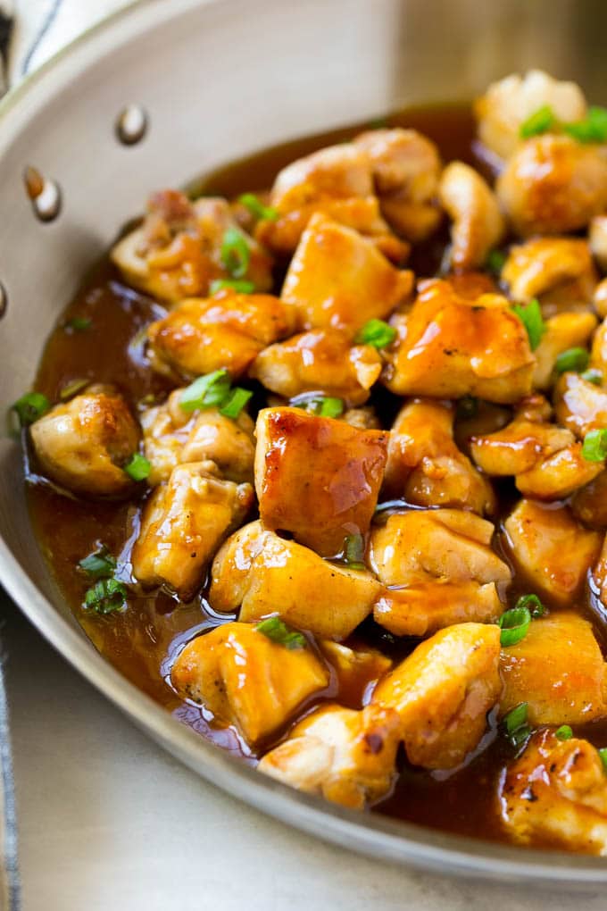 Bourbon Chicken | Sauteed Chicken | Chicken Stir Fry | Easy Chicken Recipe #chicken #dinner #jonep Bourbon chicken in a skillet coated in sauce and topped with green onions.