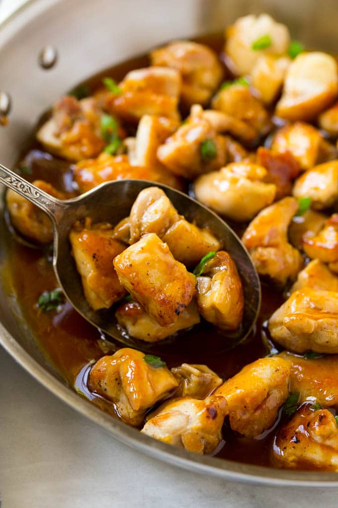 Bourbon Chicken | Sauteed Chicken | Chicken Stir Fry | Easy Chicken Recipe #chicken #dinner #jonep A pan of bourbon chicken with a serving spoon in it.