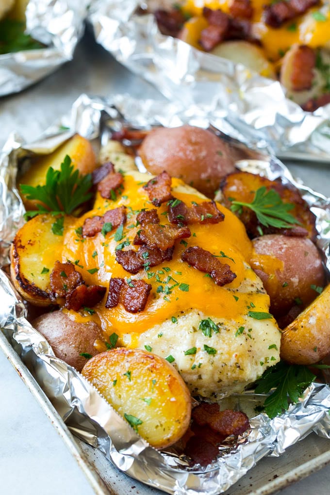 Bacon Ranch Chicken Foil Packets | Chicken in Foil | Foil Packet Recipe | Ranch Chicken #ranchchicken #grilling #chicken #foilpacket #foilpackets #bacon #dinner #jonep Chicken in foil topped with cheddar cheese and bacon.