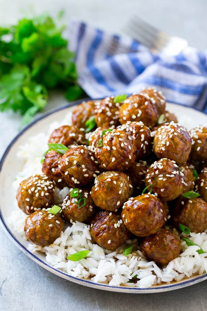 Teriyaki Meatballs Recipe | Asian Meatballs Recipe | Easy Meatball Recipe | Appetizer Meatballs #meatballs #teriyaki #beef #rice #dinner #jonep Teriyaki meatballs served over a bed of steamed rice and garnished with sesame seeds.