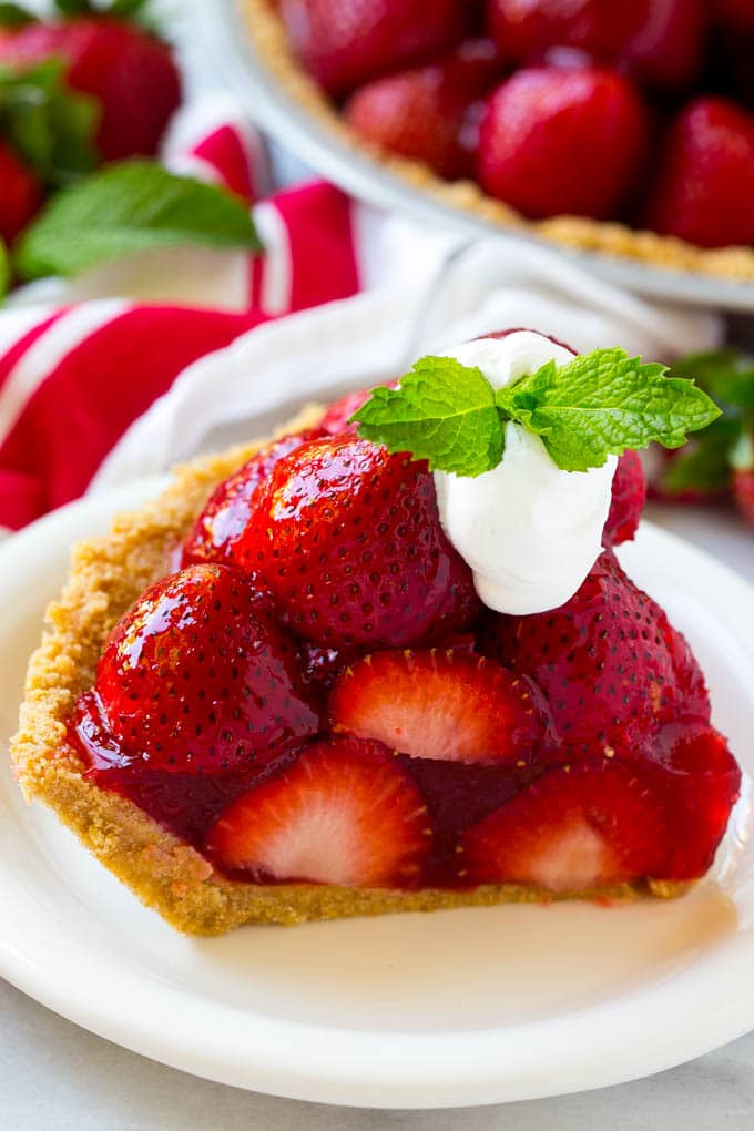 No Bake Strawberry Pie Recipe | Fresh Strawberry Pie | Strawberry Pie Recipe | No Bake Pie Recipe #strawberry #strawberrypie #nobake #nobakepie #dessert #jonep A slice of no bake fresh strawberry pie with whipped cream on top.