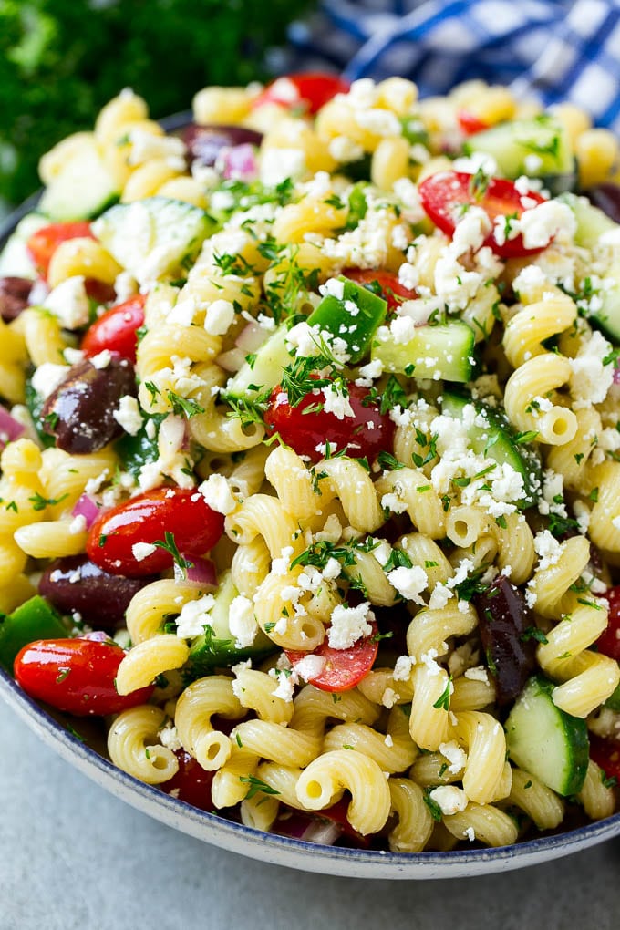 Greek Pasta Salad | Easy Pasta Salad | Vegetable Pasta Salad #pasta #salad #greek #cucumber #tomato #vegetarian #dinner #jonep A bowl of Greek pasta salad loaded with feta cheese, olives, tomatoes, cucumber and bell peppers.