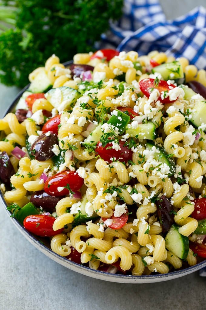 Greek Pasta Salad | Easy Pasta Salad | Vegetable Pasta Salad #pasta #salad #greek #cucumber #tomato #vegetarian #dinner #jonep Greek pasta salad in a serving bowl, garnished with parsley.