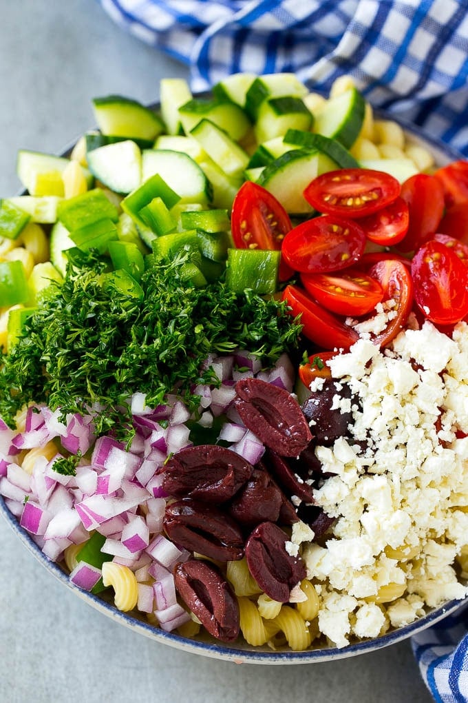 Greek Pasta Salad | Easy Pasta Salad | Vegetable Pasta Salad #pasta #salad #greek #cucumber #tomato #vegetarian #dinner #jonep Cherry tomatoes, bell pepper, olives, feta, herbs and cucumbers over pasta.