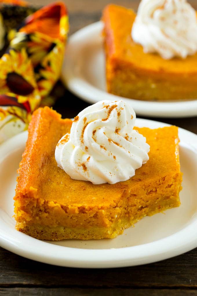 Pumpkin Gooey Butter Cake Recipe | Pumpkin Cake Recipe | Gooey Butter Cake | Pumpkin Dessert | Thanksgiving Dessert #pumpkin #cake #pumpkincake #gooeybuttercake #dessert #jonep A slice of pumpkin butter cake with a bite taken out of it.