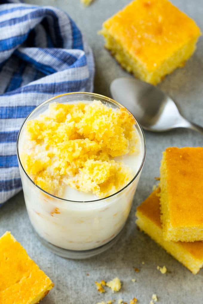 Honey Cornbread Recipe | Buttermilk Cornbread | Easy Cornbread | Homemade Cornbread | Cast Iron Cornbread #cornbread #honey #buttermilk #bread #jonep A glass of milk with cornbread crumbled into it.