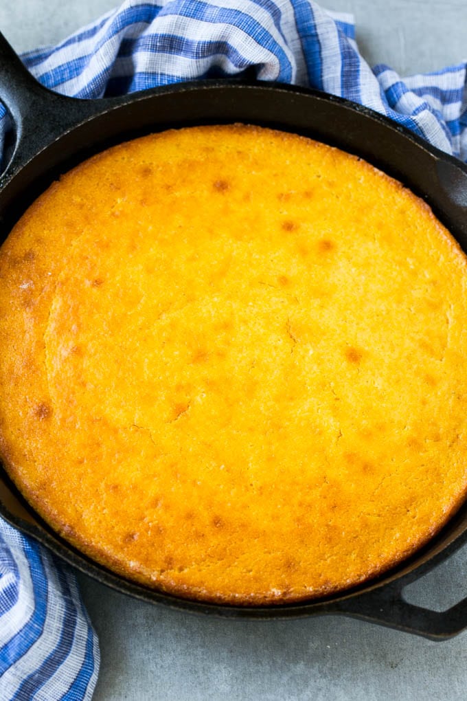 Honey Cornbread Recipe | Buttermilk Cornbread | Easy Cornbread | Homemade Cornbread | Cast Iron Cornbread #cornbread #honey #buttermilk #bread #jonep A cast iron pan of honey cornbread.