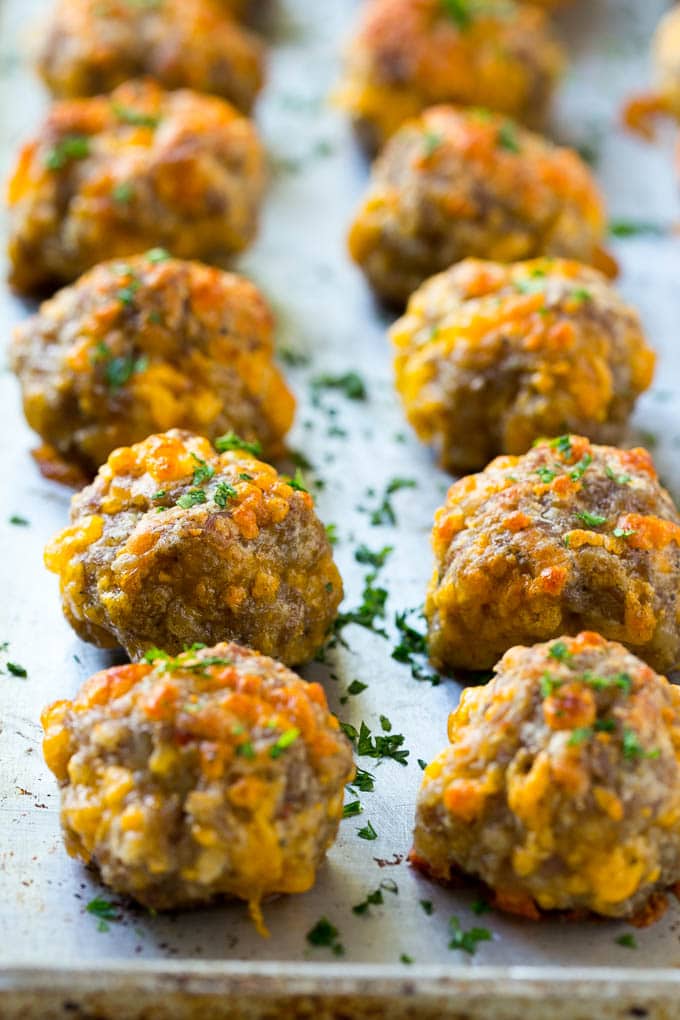 Sausage Cheese Balls Recipe | Sausage Balls Recipe | Bisquick Sausage Balls #sausage #sausageballs #balls #appetizer #cheeseballs #jonep Cooked meatballs on a baking sheet.