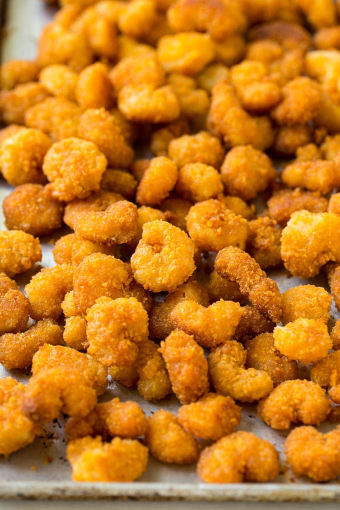 Sesame Shrimp Recipe | Crispy Shrimp | Popcorn Shrimp | Asian Shrimp | Easy Shrimp Recipe #shrimp #fried #friedshrimp #sesameshrimp #crispy #popcornshrimp #chinese #asian #dinner #jonep A pan of cooked popcorn shrimp.