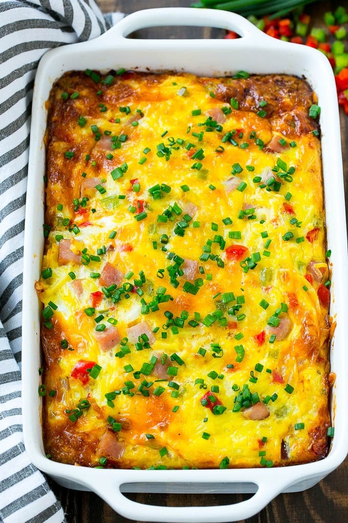 Hash Brown Egg Casserole Recipe | Breakfast Casserole with Ham | Hash Brown Casserole | Ham and Egg Casserole | Egg Casserole with Ham #casserole #breakfast #eggs #egg #hashbrown #jonep Hash brown egg casserole in a white baking dish.