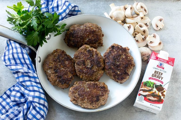 Slow Cooker Salisbury Steak Recipe | Homemade Salisbury Steak | Salisbury Steak from Scratch #steak #beef #salisbury #salisburysteak #slowcooker #crockpot #dinner #jonep Hamburger patties browned in a skillet.