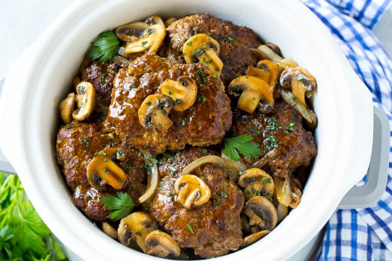 Slow Cooker Salisbury Steak Recipe | Homemade Salisbury Steak | Salisbury Steak from Scratch #steak #beef #salisbury #salisburysteak #slowcooker #crockpot #dinner #jonep A crock pot full of slow cooker salisbury steak.